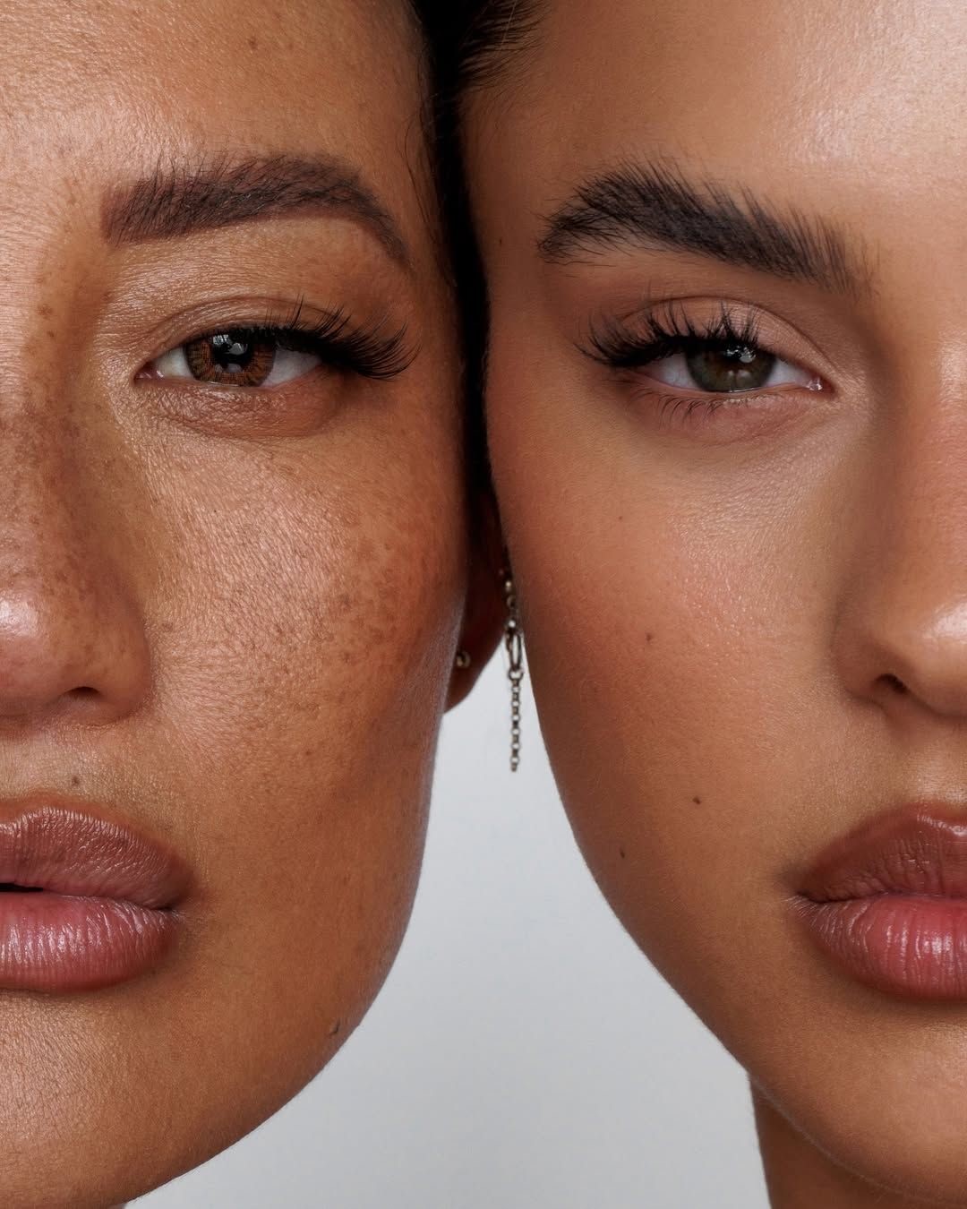 Close-up of dewy, luminous skin holding a dropper of serum